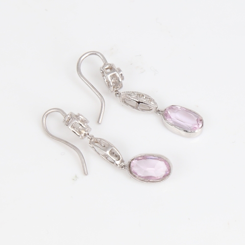 1429 - A pair of unmarked white metal pink topaz and diamond drop earrings, set with oval mixed-cut topaz a... 