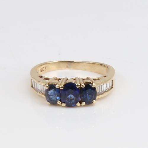 1437 - A modern 14ct gold sapphire and diamond dress ring, set with oval mixed-cut sapphires and baguette-c... 