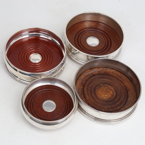 1444 - 4 Elizabeth II silver-mounted oak wine coasters, largest diameter 12.5cm (4)