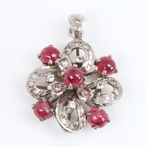 1451 - A Vintage unmarked white metal ruby and diamond flowerhead pendant, set with cabochon ruby and eight... 