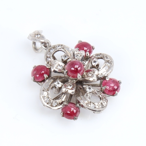 1451 - A Vintage unmarked white metal ruby and diamond flowerhead pendant, set with cabochon ruby and eight... 