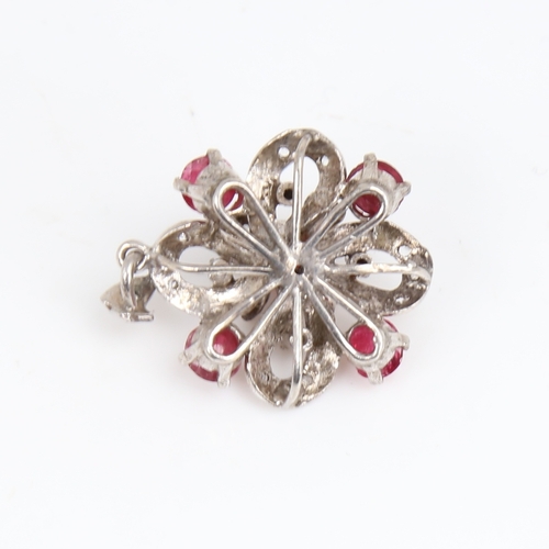 1451 - A Vintage unmarked white metal ruby and diamond flowerhead pendant, set with cabochon ruby and eight... 