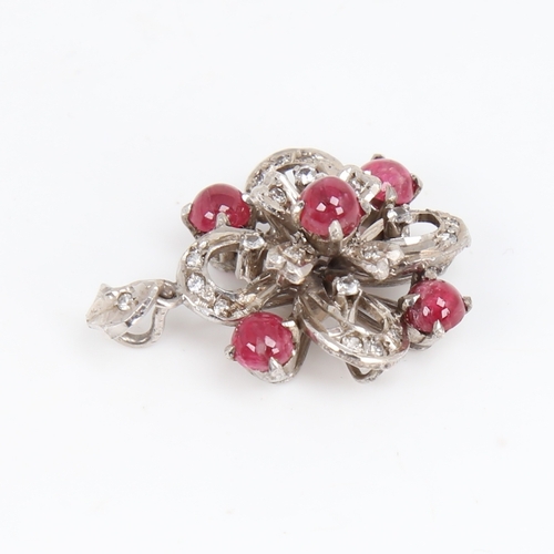 1451 - A Vintage unmarked white metal ruby and diamond flowerhead pendant, set with cabochon ruby and eight... 