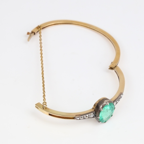 1455 - An Antique unmarked gold emerald and diamond hinged bracelet/bangle, set with 7.52ct oval mixed-cut ... 