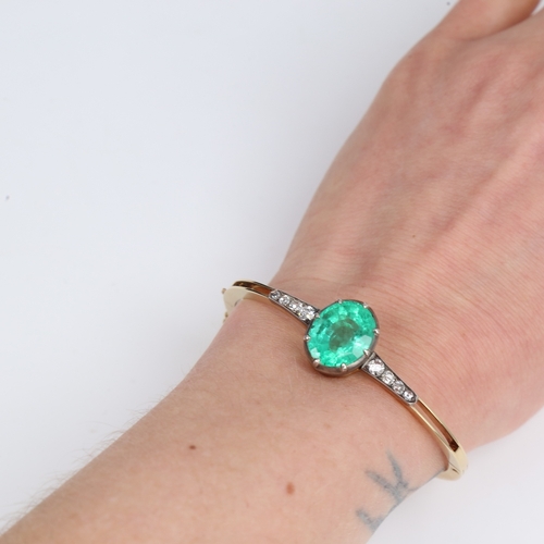 1455 - An Antique unmarked gold emerald and diamond hinged bracelet/bangle, set with 7.52ct oval mixed-cut ... 