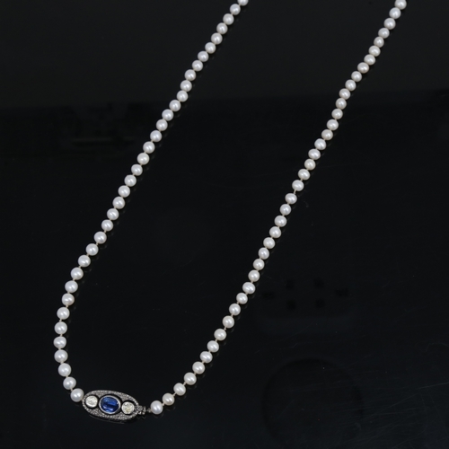 1458 - A long single-strand pearl necklace, with oxidised silver clasp set with oval mixed-cut kyanite and ... 