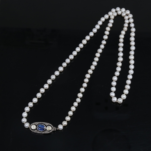 1458 - A long single-strand pearl necklace, with oxidised silver clasp set with oval mixed-cut kyanite and ... 