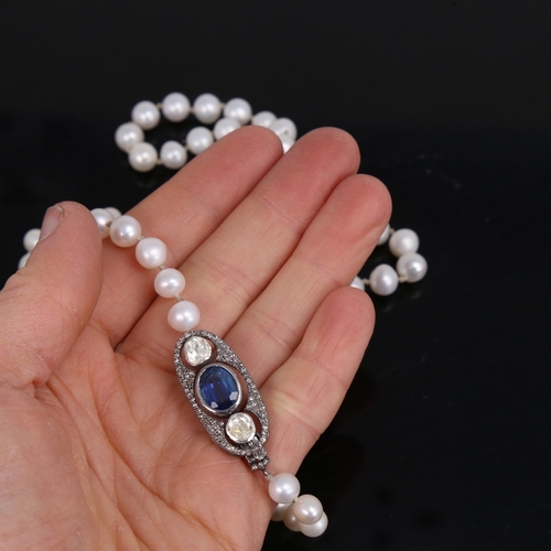 1458 - A long single-strand pearl necklace, with oxidised silver clasp set with oval mixed-cut kyanite and ... 