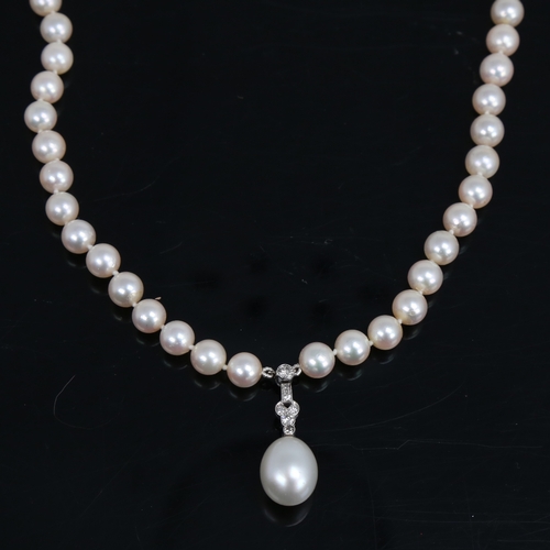 1459 - A Vintage single-strand pearl and diamond pendant necklace, with textured 14ct white gold clasps, to... 