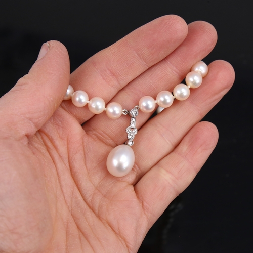 1459 - A Vintage single-strand pearl and diamond pendant necklace, with textured 14ct white gold clasps, to... 