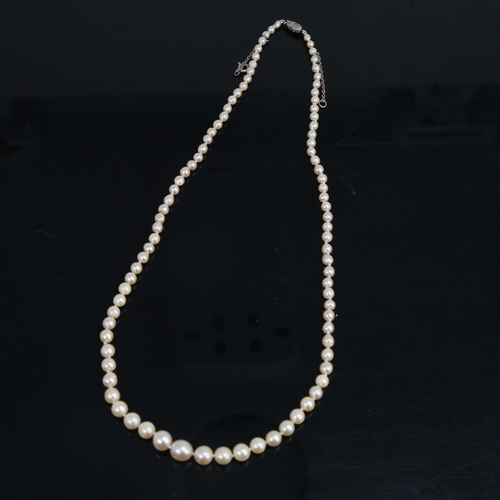 1460 - A single-strand graduated pearl necklace, with unmarked white metal rose-cut diamond set clasp, pear... 