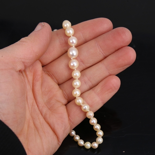 1460 - A single-strand graduated pearl necklace, with unmarked white metal rose-cut diamond set clasp, pear... 