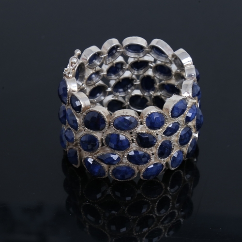 1475 - A heavy modern handmade unmarked silver sapphire cuff bracelet, organic form set with faceted caboch... 