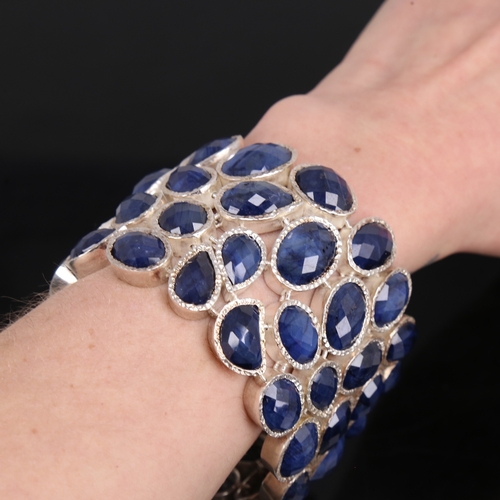 1475 - A heavy modern handmade unmarked silver sapphire cuff bracelet, organic form set with faceted caboch... 