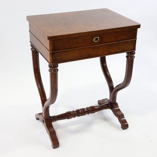 187 - A burr-walnut sewing table of rectangular form, with rising top single frieze drawer, raised on yoke... 