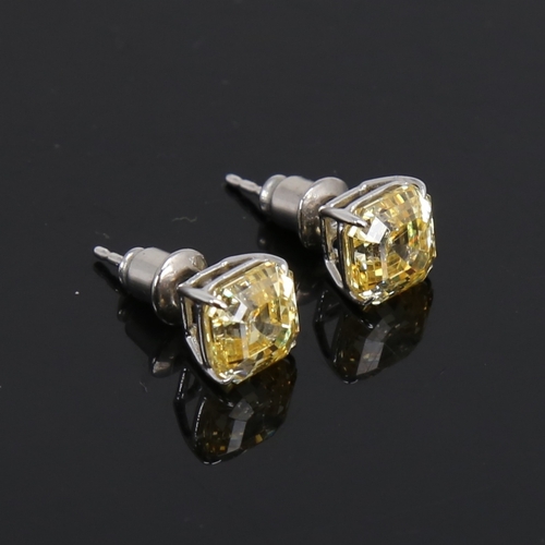 1487 - CARAT - a modern pair of 9ct white gold yellow asscher-cut cubic zirconia stud earrings, CZ width 7.... 