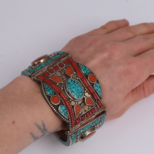 1502 - A Mexican silver-gilt stone set hinged cuff bracelet, and Treaty Aztec design necklace, length 44cm,... 