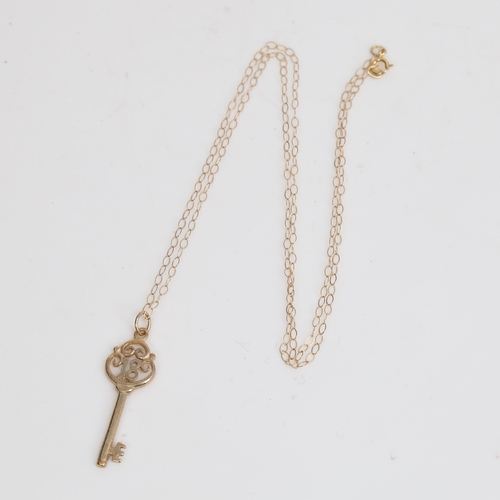 1510 - A modern 9ct gold 18th birthday key pendant necklace, on 9ct trace link chain, pendant height 28.2mm... 