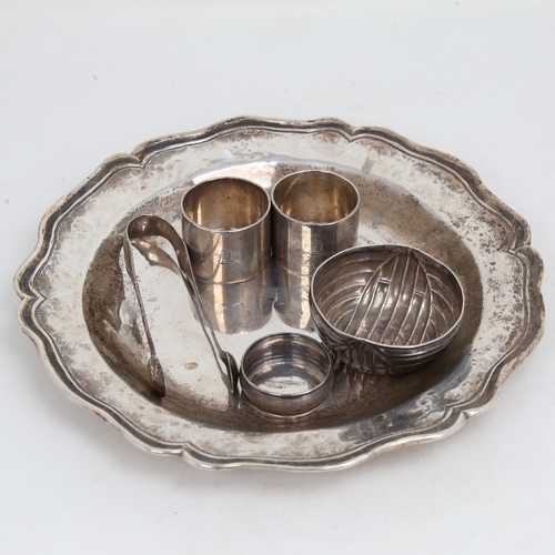 1515 - A large unmarked white metal card tray, diameter 24.5cm, 15.4oz, pair of silver napkin rings, unmark... 