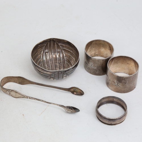 1515 - A large unmarked white metal card tray, diameter 24.5cm, 15.4oz, pair of silver napkin rings, unmark... 