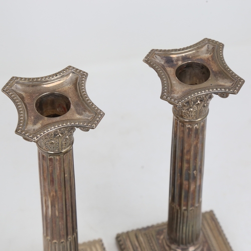 1523 - A pair of George V silver Corinthian column table candlesticks, stepped bases with removeable sconce... 