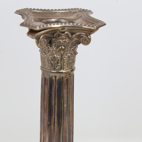 1523 - A pair of George V silver Corinthian column table candlesticks, stepped bases with removeable sconce... 