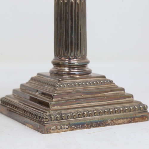 1523 - A pair of George V silver Corinthian column table candlesticks, stepped bases with removeable sconce... 