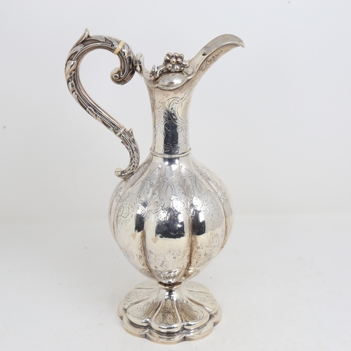 1524 - A William IV silver baluster Claret/hot water jug, lobed form with allover foliate engraved decorati... 