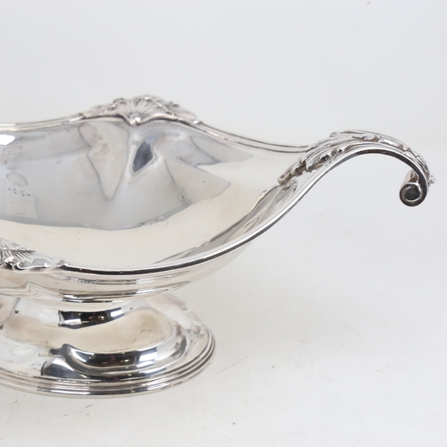 1525 - A large George V silver 2-handled table centre fruit bowl, oval form with cast scrolled acanthus lea... 