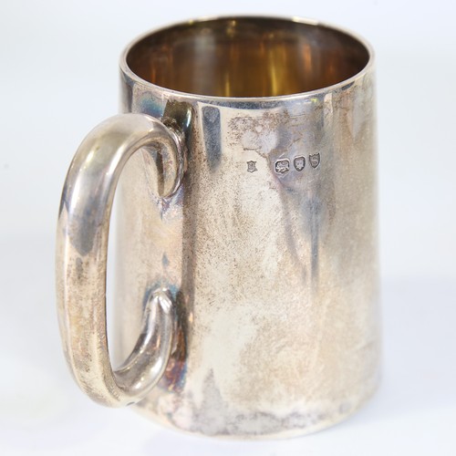 86 - A Victorian silver half pint tankard, tapered cylindrical form with C-shaped handle and gilt interio... 