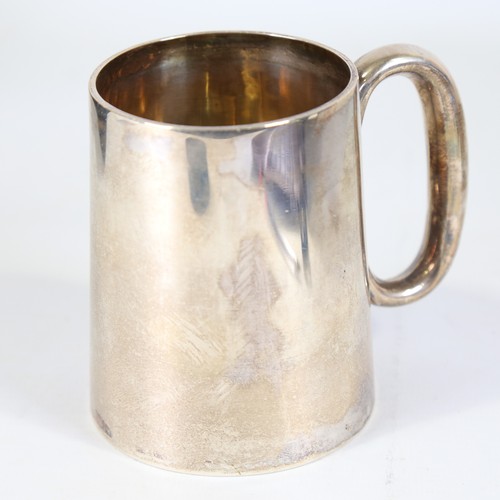 86 - A Victorian silver half pint tankard, tapered cylindrical form with C-shaped handle and gilt interio... 