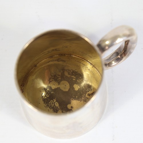 86 - A Victorian silver half pint tankard, tapered cylindrical form with C-shaped handle and gilt interio... 