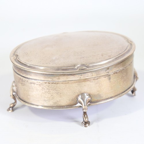 95 - An Edwardian silver dressing table jewel box, oval form on hoof feet, by Goldsmiths and Silversmiths... 