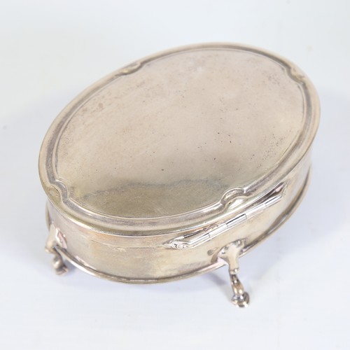 95 - An Edwardian silver dressing table jewel box, oval form on hoof feet, by Goldsmiths and Silversmiths... 