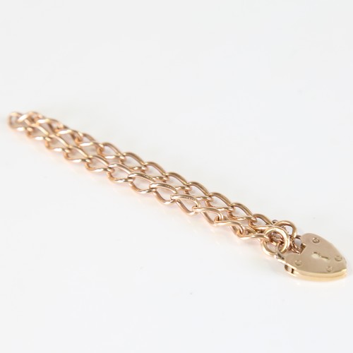 97 - A mid-20th century 15ct rose gold curb link bracelet, with 9ct heart padlock locket clasp, hallmarks... 