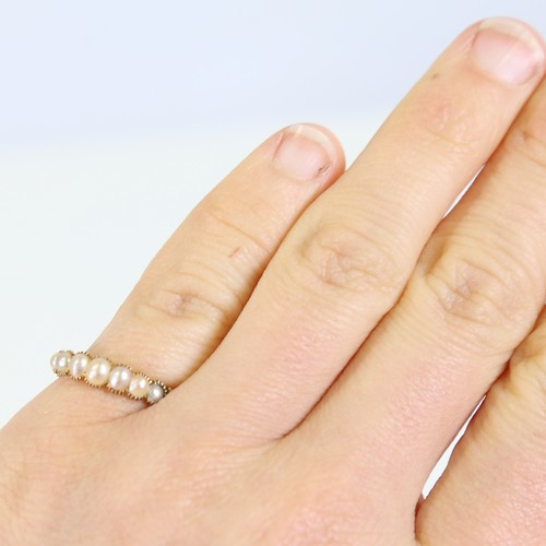 100 - A Georgian unmarked gold graduated 7-stone split pearl ring, collet setting with engraved foliate sh... 