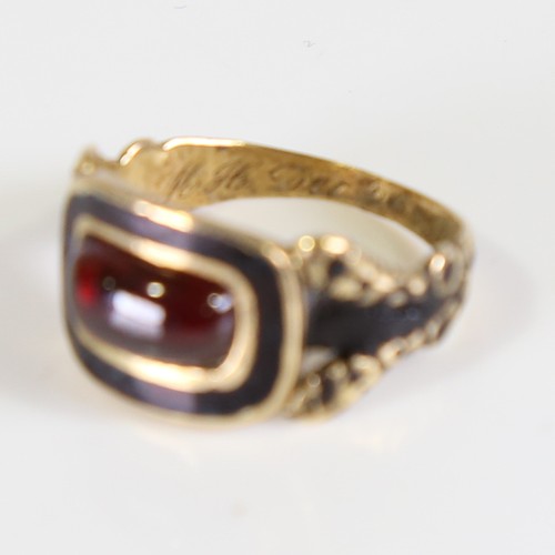 101 - A Georgian 18ct gold garnet and black enamel mourning ring, set with oval cabochon garnet with foil ... 