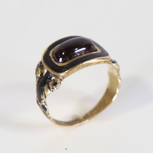 101 - A Georgian 18ct gold garnet and black enamel mourning ring, set with oval cabochon garnet with foil ... 