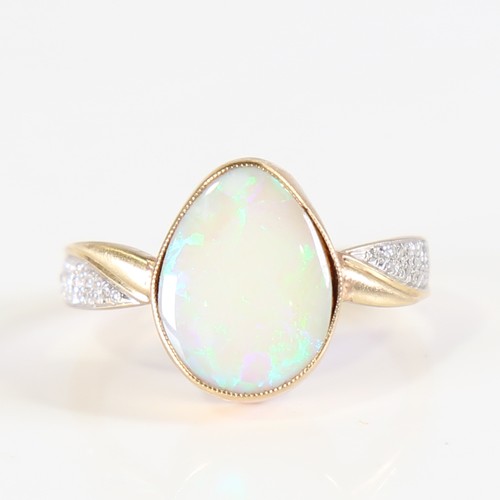 106 - A modern 9ct gold opal and diamond dress ring, set with pear cabochon opal and eight cut diamond sho... 