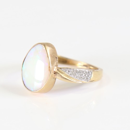 106 - A modern 9ct gold opal and diamond dress ring, set with pear cabochon opal and eight cut diamond sho... 