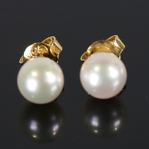 107 - A pair of handmade 14ct gold Japanese whole pearl earrings, plain settings with stud fittings, pearl... 