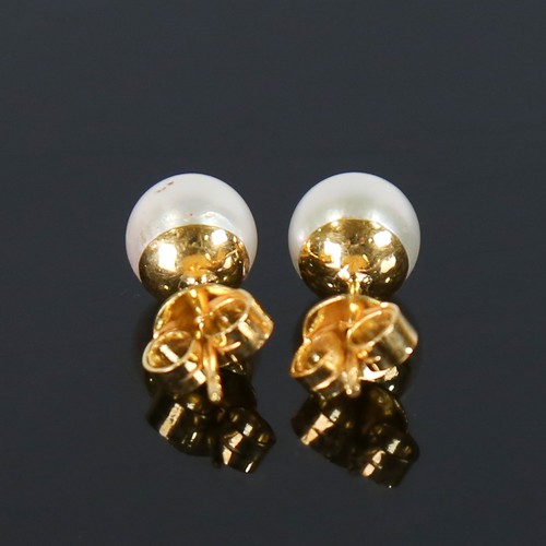 107 - A pair of handmade 14ct gold Japanese whole pearl earrings, plain settings with stud fittings, pearl... 