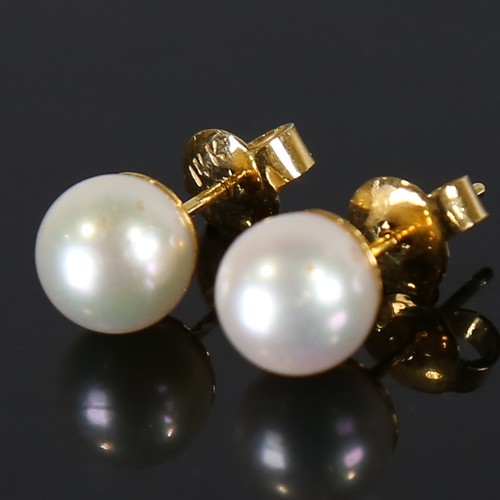 107 - A pair of handmade 14ct gold Japanese whole pearl earrings, plain settings with stud fittings, pearl... 