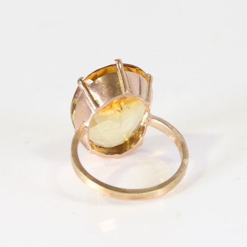 129 - A large late 20th century citrine dress ring, unmarked gold set with large oval mixed cut citrine, s... 