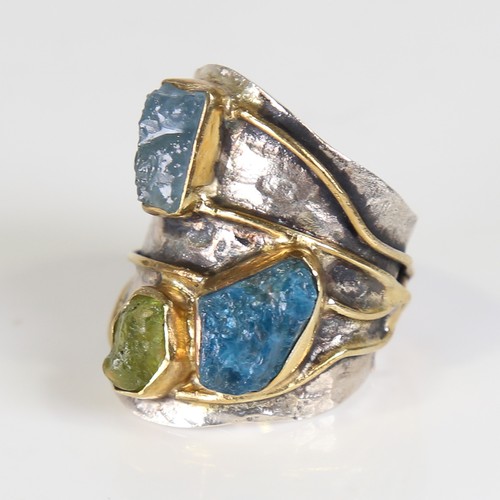 131 - A large modern silver gem-set ring, naturalistic settings with gilded bands, rough cut gemstones inc... 