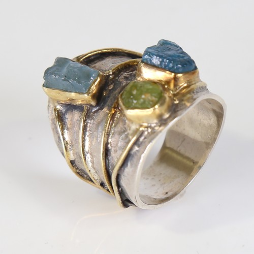 131 - A large modern silver gem-set ring, naturalistic settings with gilded bands, rough cut gemstones inc... 