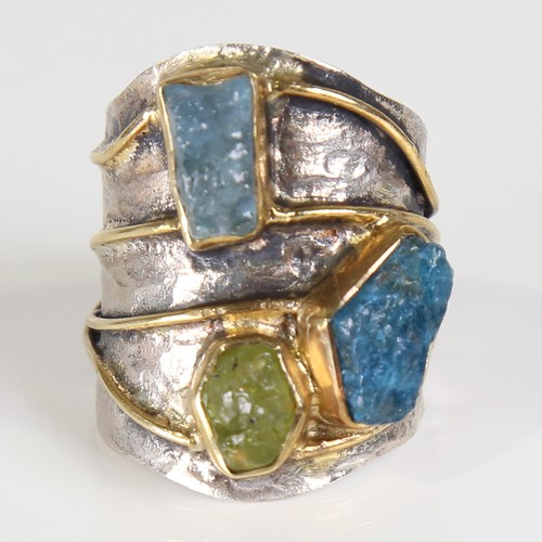 131 - A large modern silver gem-set ring, naturalistic settings with gilded bands, rough cut gemstones inc... 