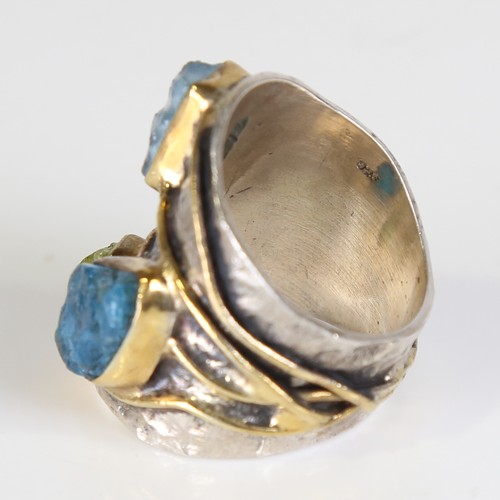 131 - A large modern silver gem-set ring, naturalistic settings with gilded bands, rough cut gemstones inc... 