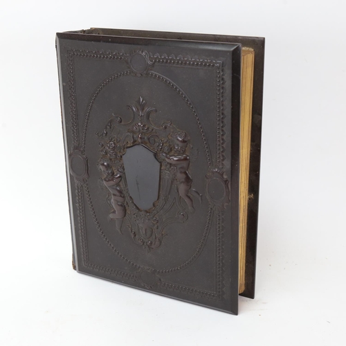 137 - A 19th century French relief moulded cherub family photograph album, majority filled with period pho... 