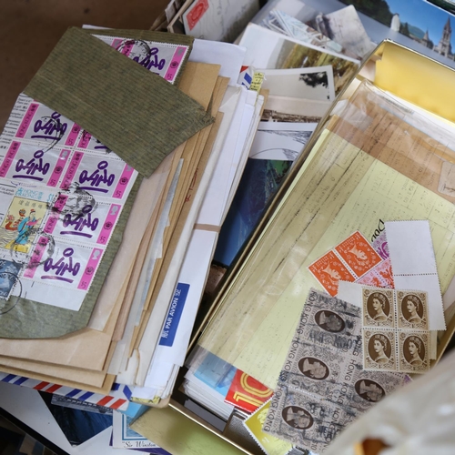 147 - A large quantity of postage stamp albums, loose stamps, and topographical postcards (2 boxes)